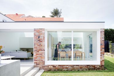 The red-brick form steps down the site, gaining ceiling height while ensuring that the roof is not visible from the street.