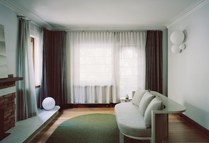 The proportions of the new marble hearth have been exaggerated to register the length of the living room.