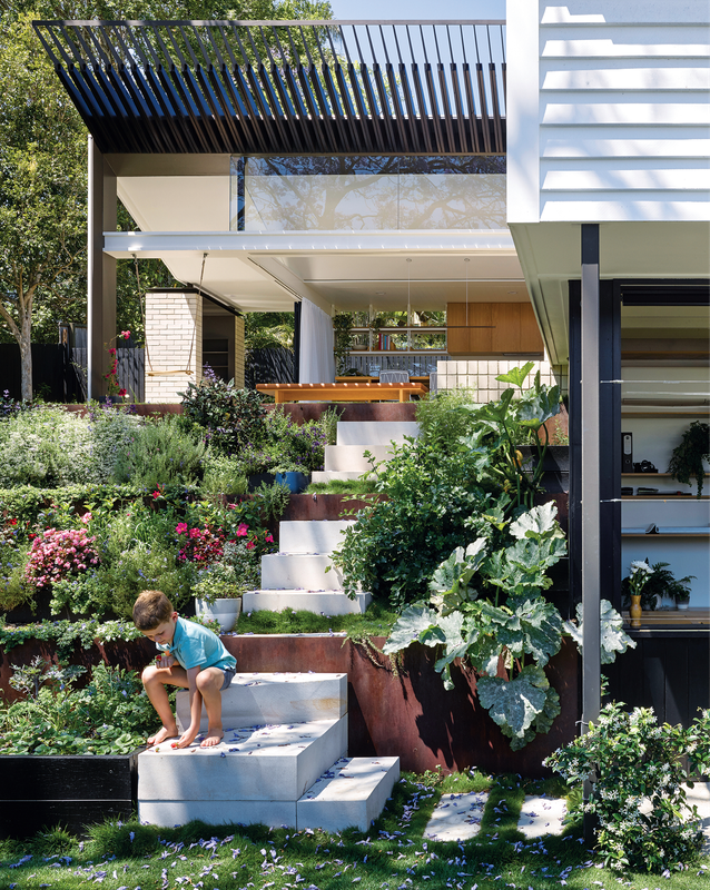 A terraced garden, filled with vegetables, herbs and blooms, descends to the architecture studio on the lower floor of the house.