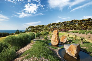 Dramatic rocks tower from Circular ponds in the water feature by artist Ashika Ostapkowicz.