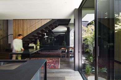 The kitchen and dining area borrow light and fresh air from the adjacent courtyard.