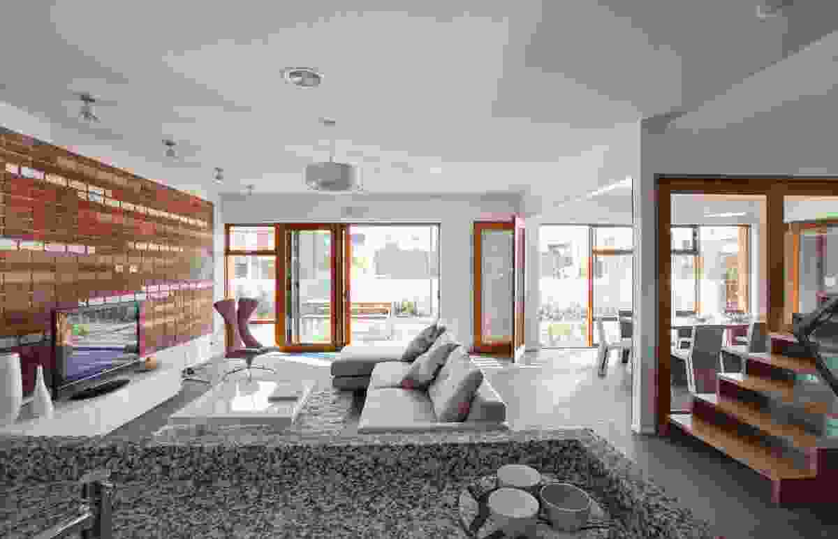 Recycled bricks are artfully arranged to demonstrate the reverse-brick veneer construction as a feature in the living room.
