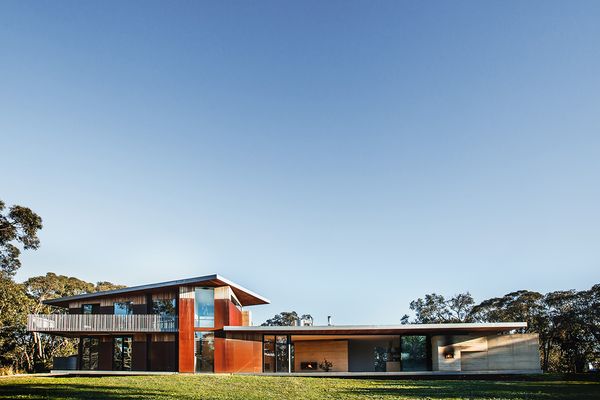 The main anchoring wall is rammed earth, Corten steel encases the stairwell, the first floor is clad in silvertop ash shiplap, while supports, balustrading and fascias are  galvanized steel.