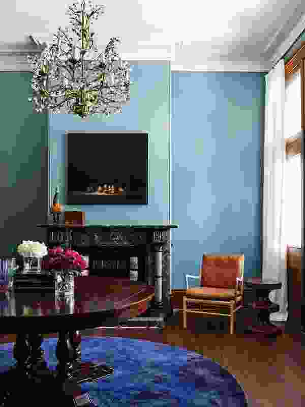 The moody hues of the blue walls provide a backdrop to a collection of antique furniture. Photograph: Anson Smart.