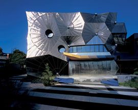 The main facade of the building appears as a series of intersecting cones. Image: Derek Swalwell