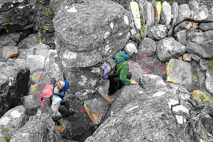 Walkers navigate rocky terrain in the Grampians National Park. 