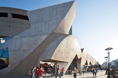 Hamer Hall’s riverside levels are cast as a virtual proscenium, with a casual pattern of drapery in its window shaping that seems pulled aside to reveal the life in the foyers and bars.