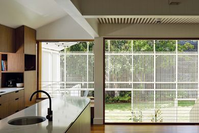 An openable wall draws light and air from the outdoor room into living spaces.