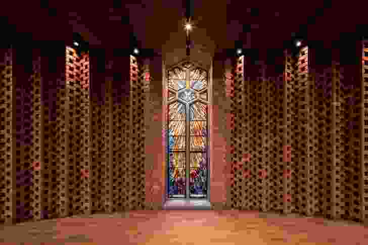 The folded brick screen behind the baptismal font incorporates a salvaged stained-glass window.