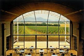 A fully glazed wall and free-standing steel screen frame the restaurant’s view of the vineyard.