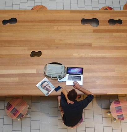 A library user makes use of the building’s free wi-fi at the Peanut table.