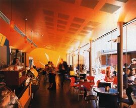 The cafe, opening onto the shared plaza.