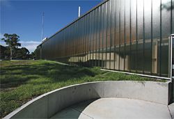 The circular concrete entry patio at the north-west corner of the building.