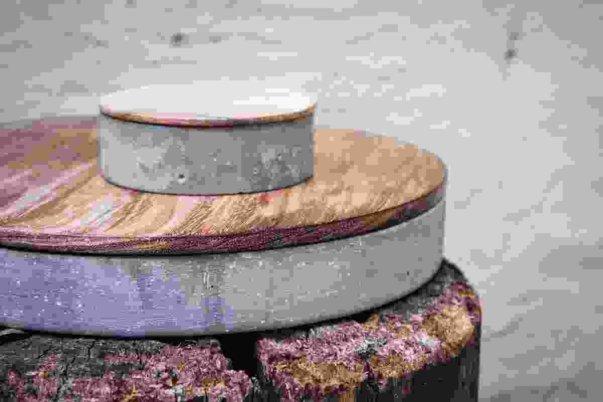Round Concrete Container features 
an Australasian timber lid.
