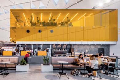 The commercial kitchen is visible through the glass walls of the kitchen, allowing customers to see the food production and delivery.