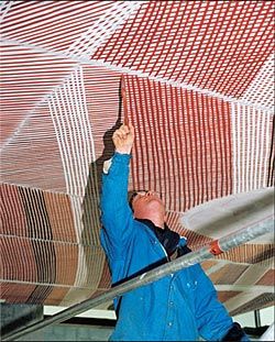 John Mawurndjul’s  Mardayin at Milmilngkan being painted onto the bookshop ceiling. Image: Philippe Ruault