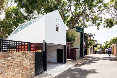 The studio presents a modest facade to the rear lane, but adopts a more playful form to address the existing house.