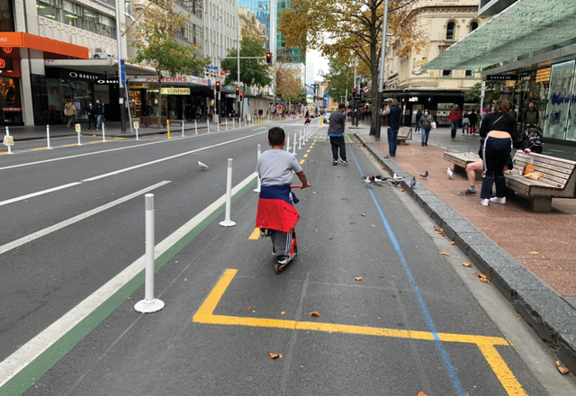 Along Queen Street in central Auckland during the COVID-19 lock-downs, emergency measures reallocated space for walking, cycling and scooting.