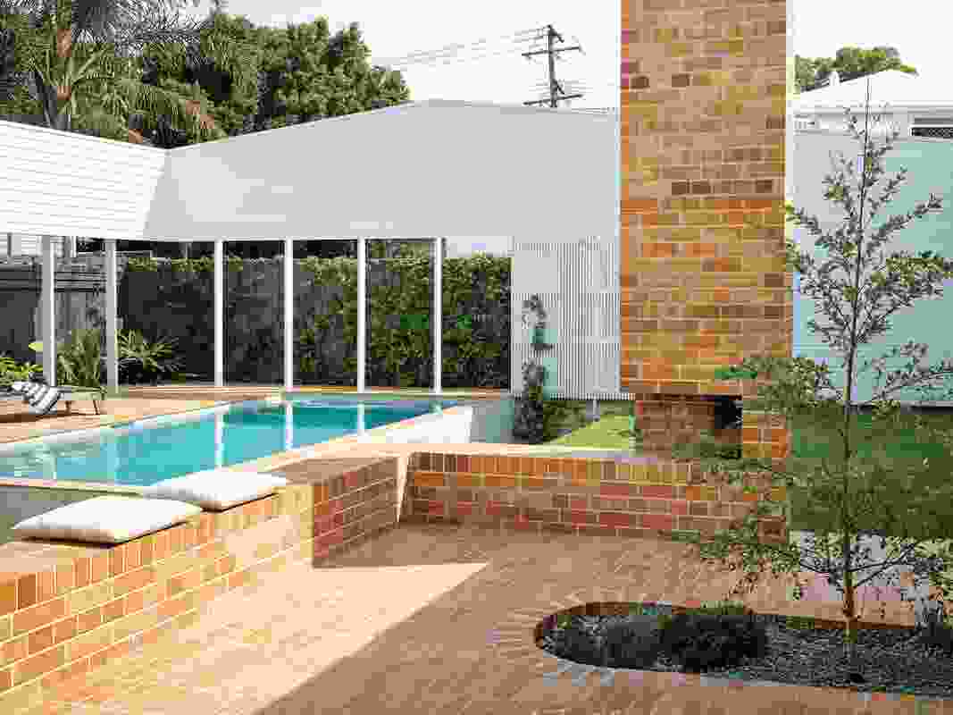 Beyond the court, a “ha-ha” ditch mitigates the need for pool fencing, enabling sight lines across the backyard.