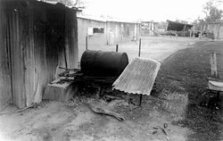 House 26. One of the many fire spots carefully placed around the living space. Each fireplace is used for different purposes or at different times of the day or depending on climatic conditions. Different wood is used depending on the heat output required. In this case the hot water for the bathroom is heated in the 44-gallon drum or “donkey” and fed directly into the bath via a piece of water pipe.