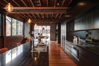 Characterized by an interplay between factory materials and sympathetic additions, the kitchen connects the main living spaces.