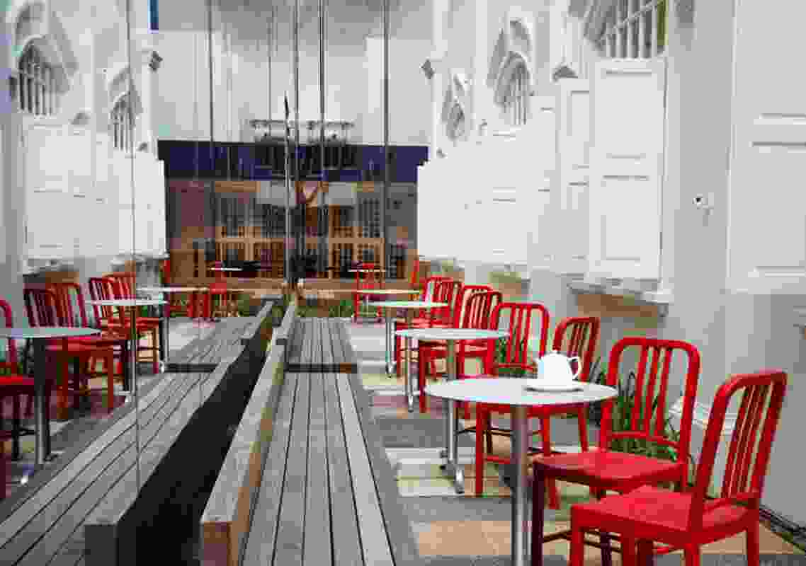 Emeco's Navy red chairs in an outdoor area in the centre of the three buildings.