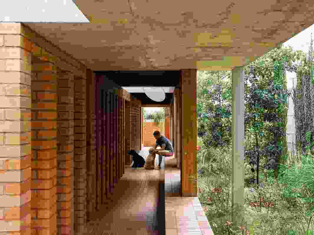 Entry to the house leads through the undercroft, past an arcade of brick piers.