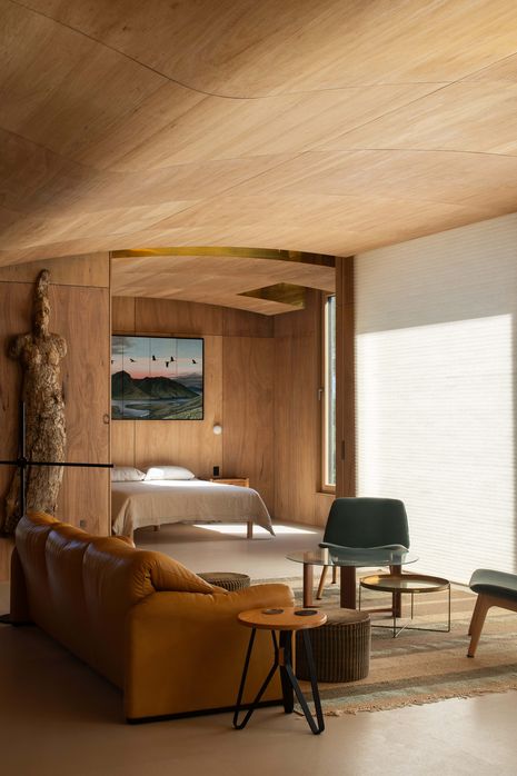 Inside, the walls and ceiling are wrapped in Tasmanian plywood. Bark sculpture: Kim Perrier; painting: Jonathan Partridge.