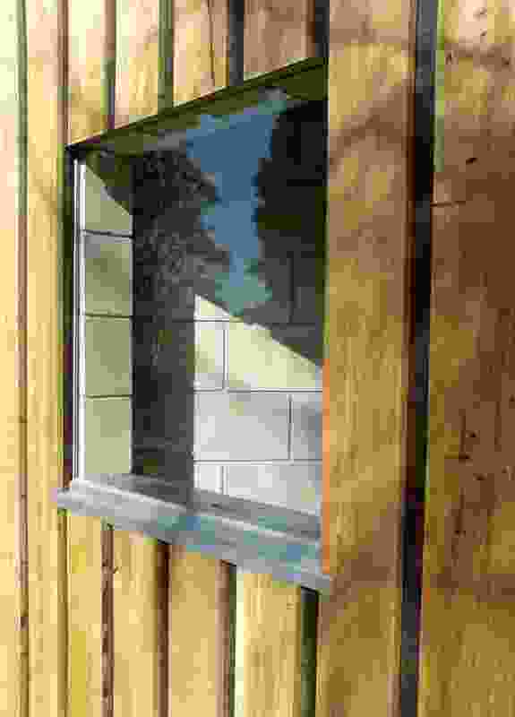 Detail of a window cut into the block wall.
