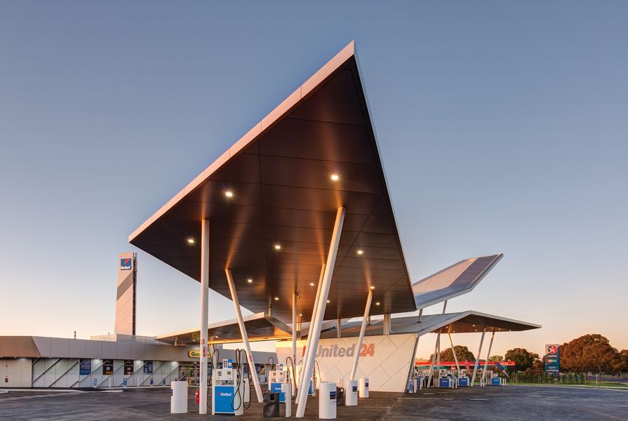 Sandwiched between an older-style petrol station and a furniture store, the building is a sculptural marvel in an otherwise featureless road.