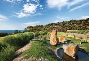 Dramatic rocks tower from Circular ponds in the water feature by artist Ashika Ostapkowicz.