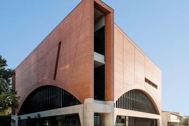 The oversized arches, with their black mullions and dark glass, recall both Louis Sullivan’s National Farmers’ Bank of Owatonna and the Harbour Bridge.