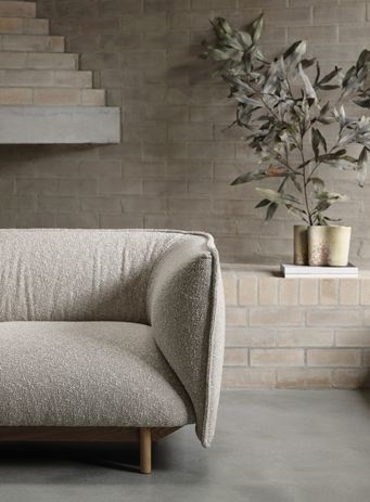 The Beam Armchair combines timber craftsmanship with upholstered comfort.