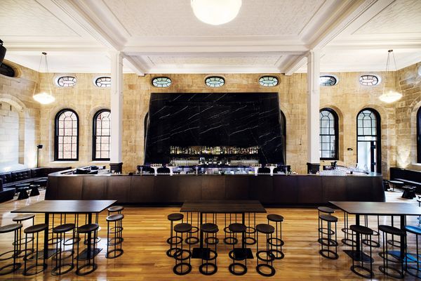 The main bar in black marble makes a brooding counterpoint to the restored sandstone.