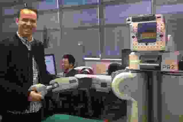 The author, Rory Hyde, looking extremely pleased to shake hands with BRETT, the Berkeley Robot for Eliminating Tedious Tasks.