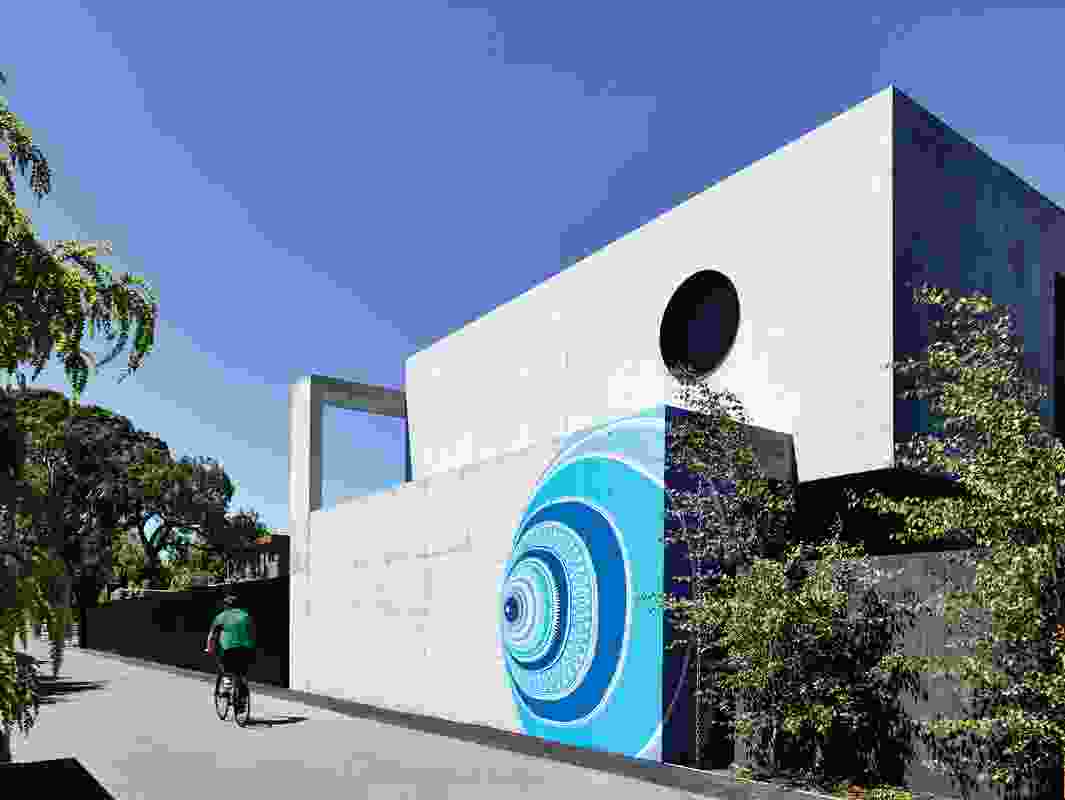A hand-painted mural by Melbourne artist Lucas Grogan features brightly on the off-form concrete exterior of the house.