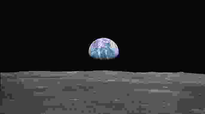 View from the Apollo 11 spacecraft taken on 20 July 1969 showing the Earth rising above the moon’s horizon.