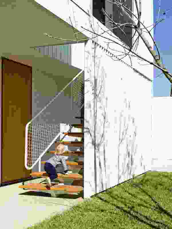 The open stair connects the studio with the backyard and encourages the use of the upper level.
