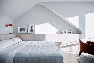 A recessed niche in the bedroom wall makes reference to the form of the original attic space.