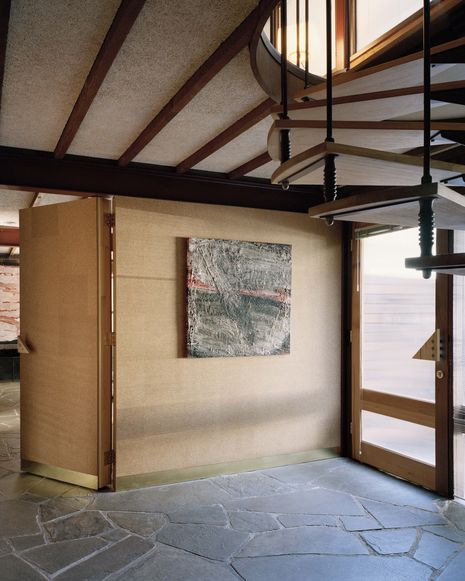 A spiral stair links the house’s three levels. Artwork: Robert Hirschmann.