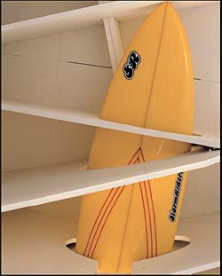 A surfboard
stored under the
house within a joist.