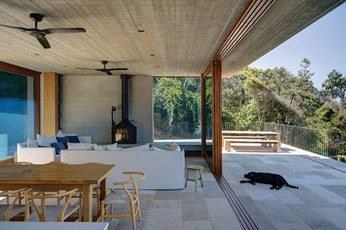 A cast-iron fireplace and sandstone flooring help to set the living level apart.