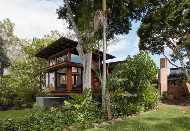 The design of the new house preserves the lush landscape setting that first attracted the clients.