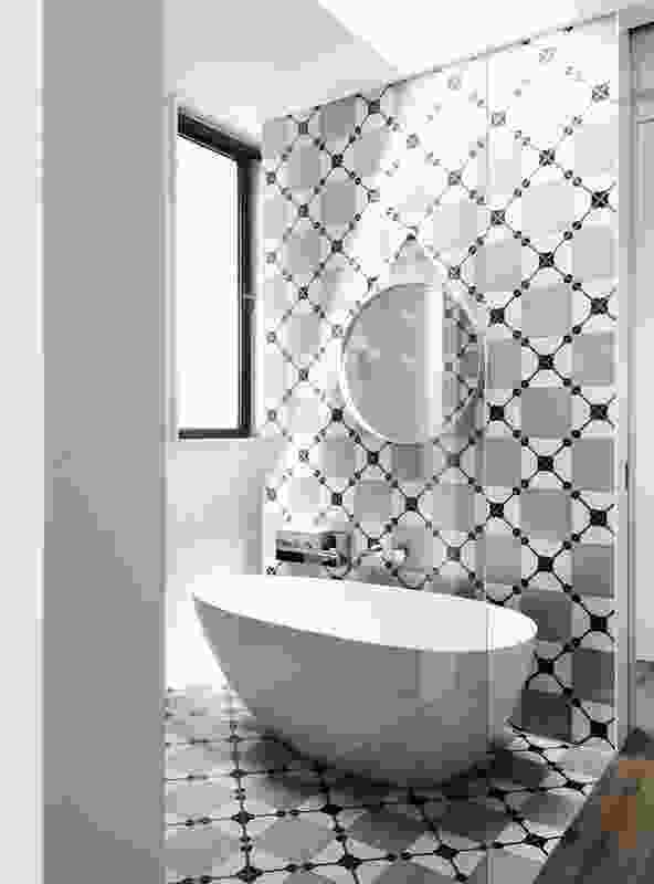 A continuous wall-to-floor monochromatic tile surface makes a bold statement in the ensuite.