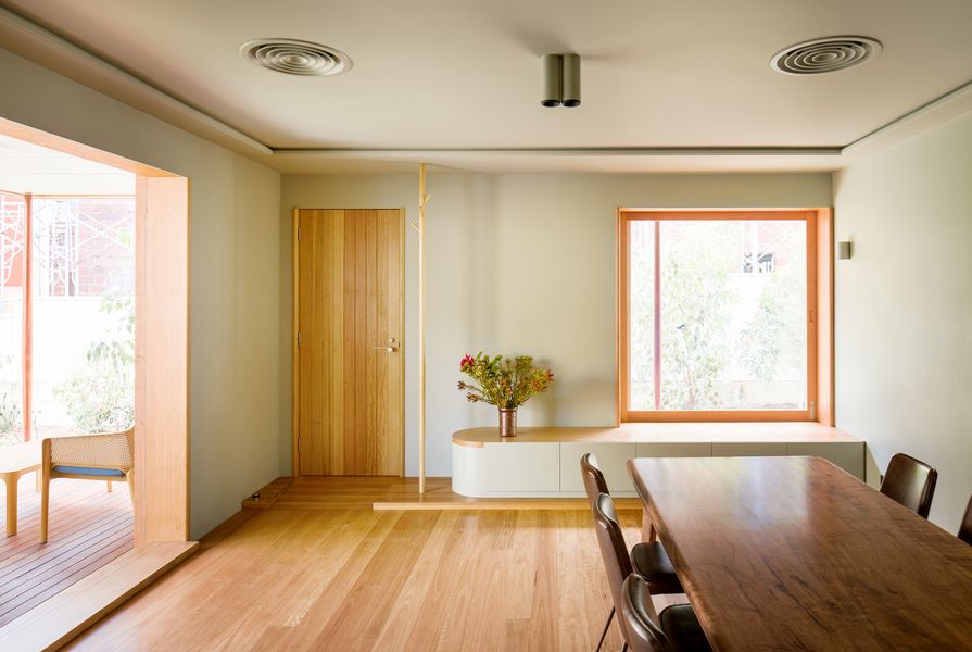 A built-in window seat in the new dining room overlooks the landscaped garden.