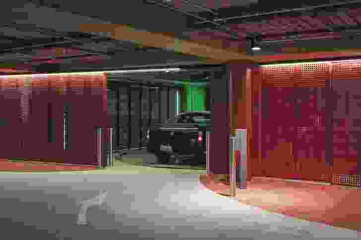 In contrast to the icy-white exterior, Geyser’s underground car park is nightclub-like in pillar-box red with neon lighting. A ‘robotic’ 165-car stacking system whisks cars away into a compact space devoid of human activity.