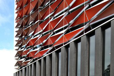 The new BLaKC by FJMT sports a facade of red aluminium sunscreens.