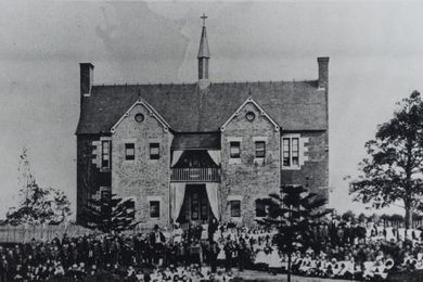 Roman Catholic Orphan School, Parramatta, view of staff and orphans assembled in front of two storey brick building, c. 1870s - 1880s