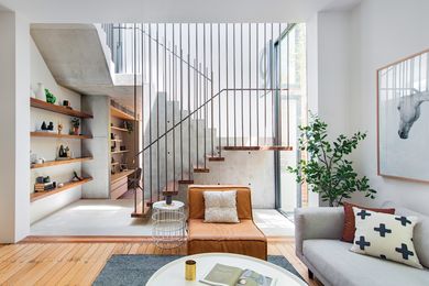 A new staircase in a central atrium marks the transition from old to new in a robust palette of concrete, recycled timber, steel and glass. Artwork: Maricou, Silver Mare.