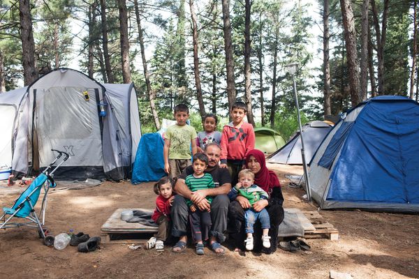 Abdisalam and his wife Rauha with their six children in a forest camp near the BP service station refugee camp of Evzoni, Greece. They left their home in Deir ez-Zor, Syria, in September 2012, and after spending years in Lebanon and Turkey they arrived in Greece two months before this photo was taken.